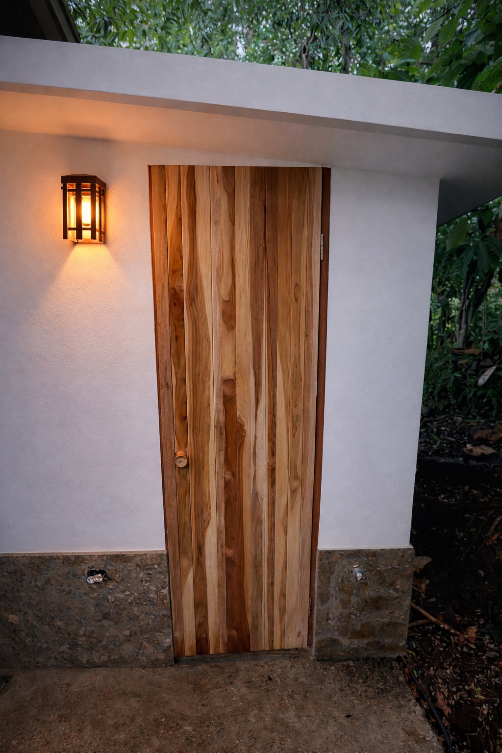 Teak sauna door beside the tropical gardens