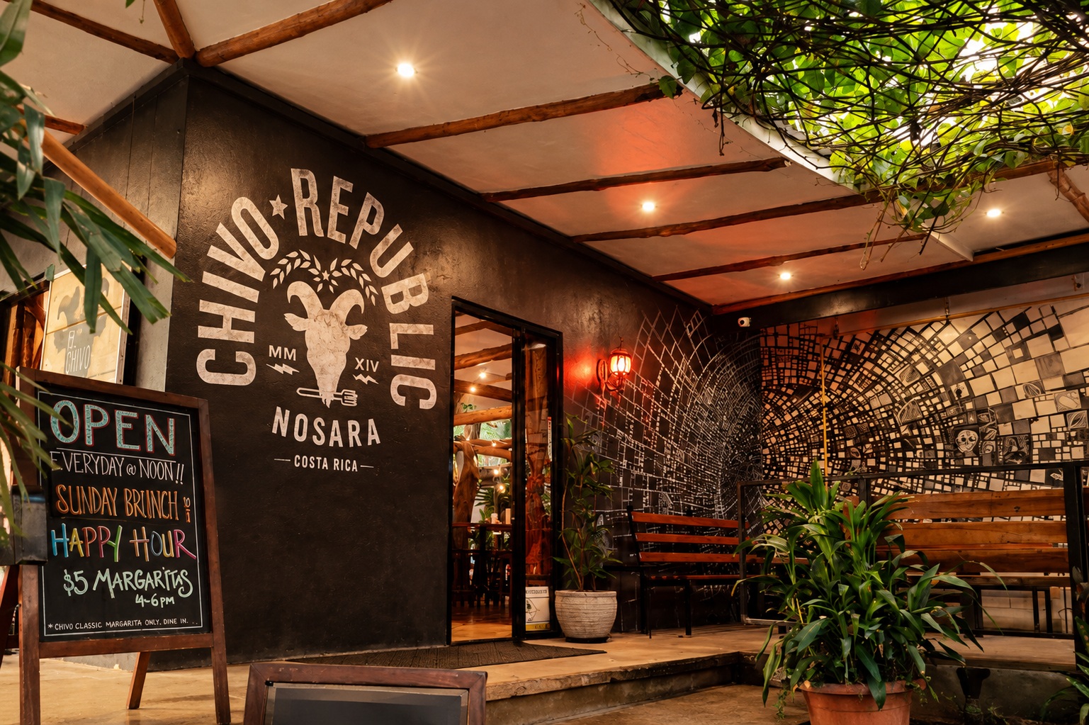 Entrance to El Chivo in Nosara — hand-painted Chivo Republic mural, chalkboard specials, and leafy patio.